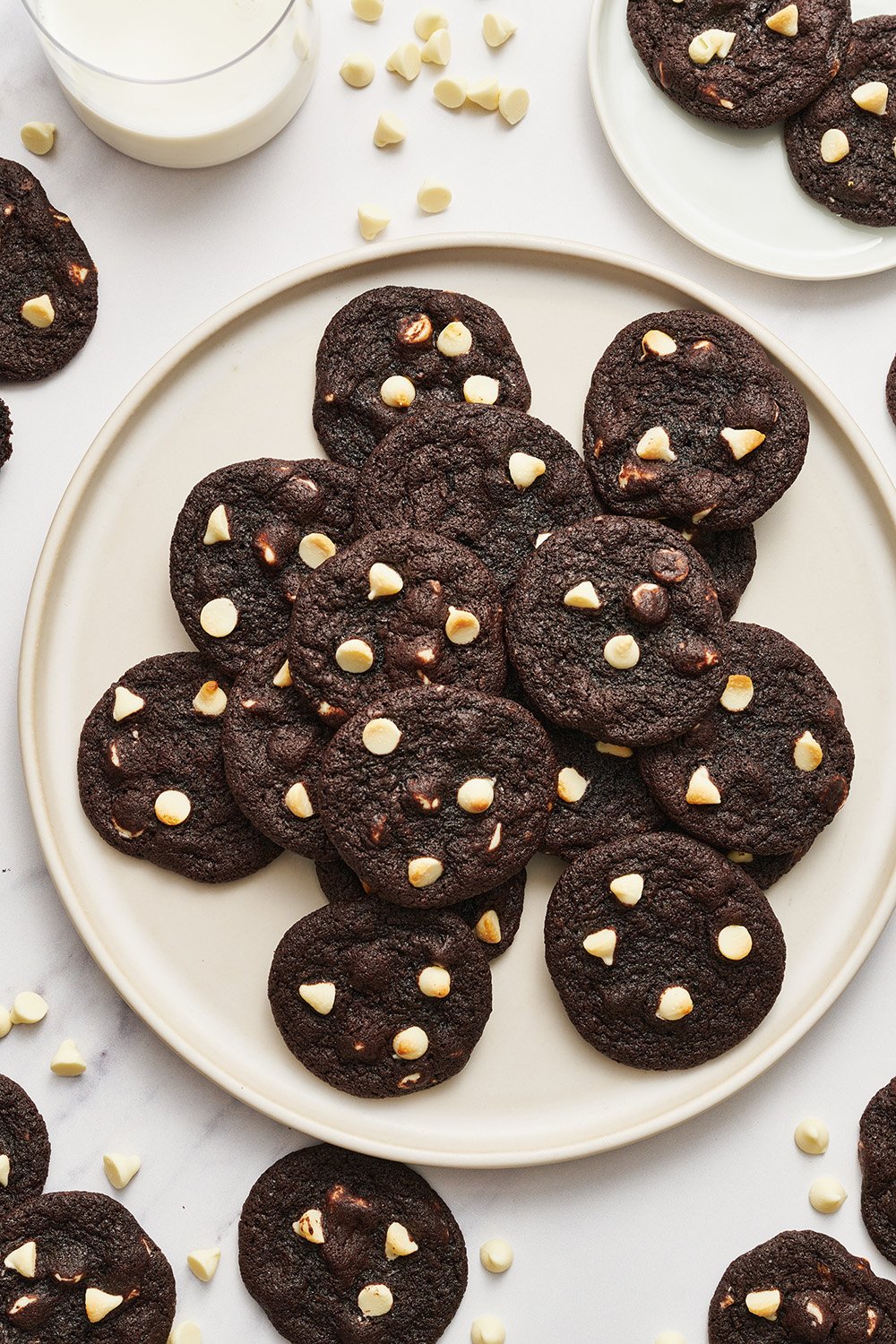 a plate of small black & white chipper cookies on a plate.