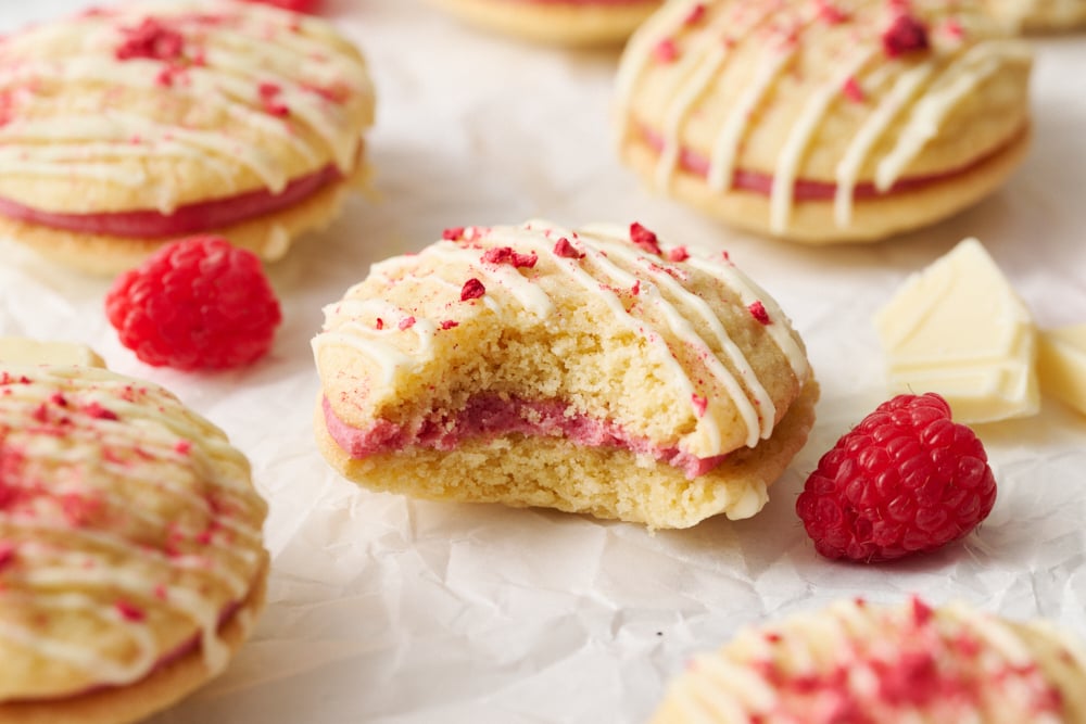 a Raspberry Cream Sandwich Cookie with a bite taken out.