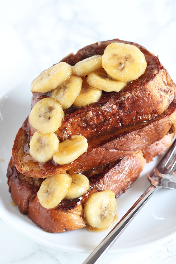 Bananas Foster French Toast feature a caramelized brown sugar banana topping and a rich Challah french toast. The perfect start to any morning!