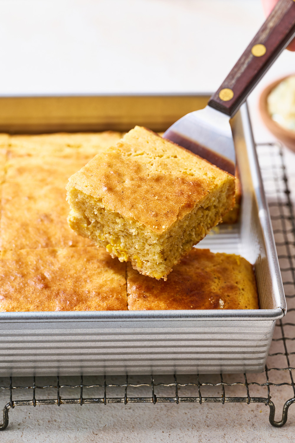 pan of baked cornbread with a slice lifted out