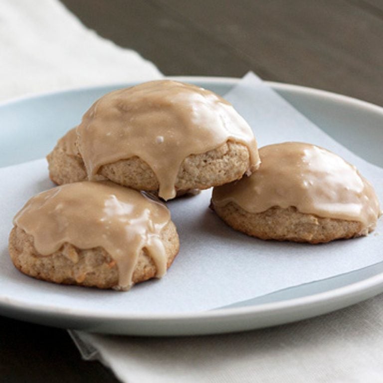 three caramel apple cookies on a white plate.