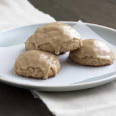 three caramel apple cookies on a white plate.