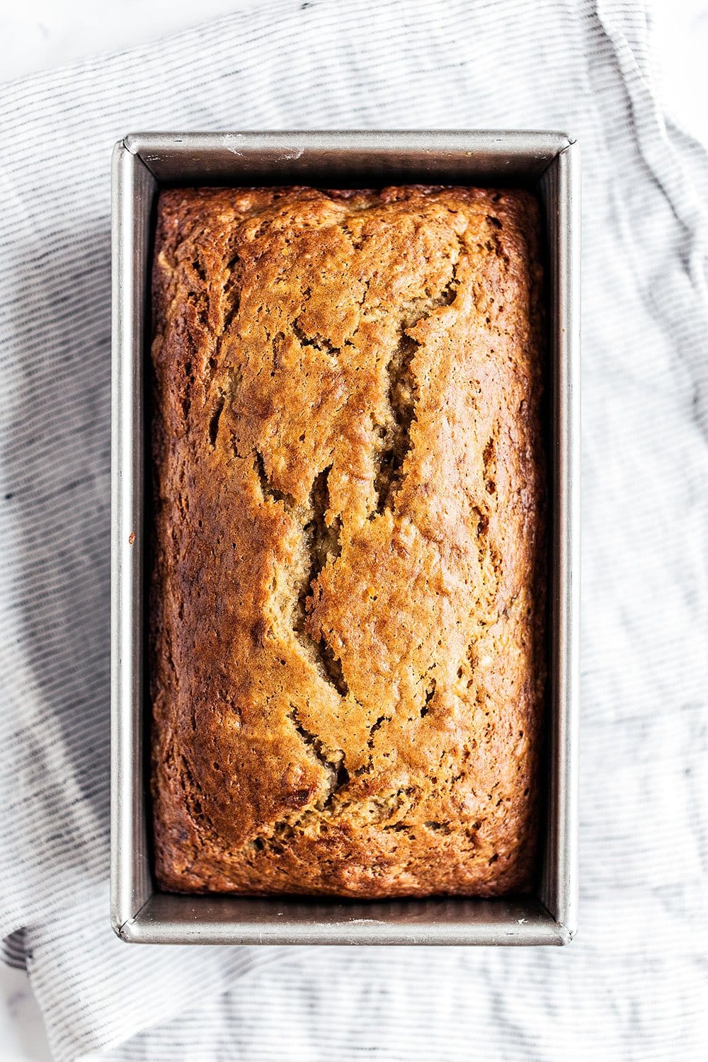 This is the best ever easy banana bread recipe with a super moist and tender texture and tons of sweet banana flavor. Everyone loves this recipe!