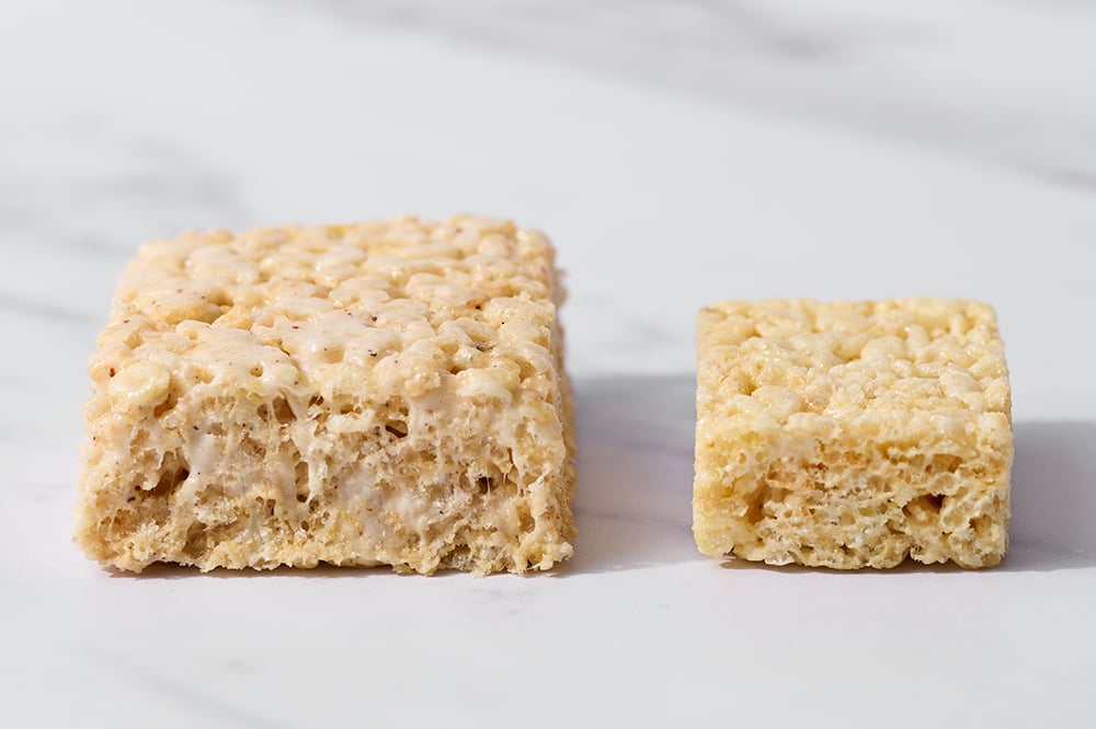 showing the difference in thickness, size and texture of a real store-bought Rice Krispie Treat vs. our homemade Brown Butter Rice Crispy Treats 