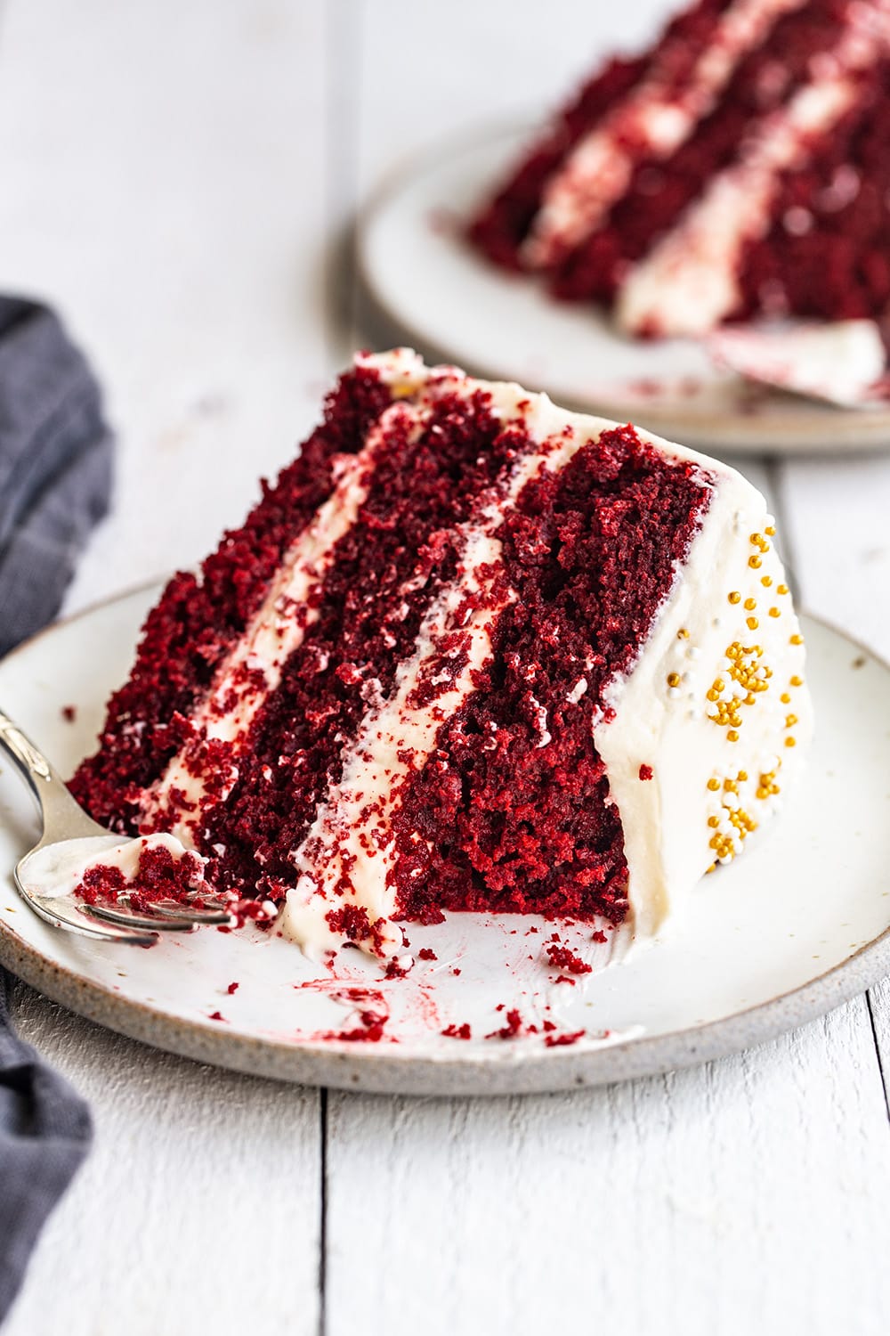 A slice of Red Velvet Cake with cream cheese frosting