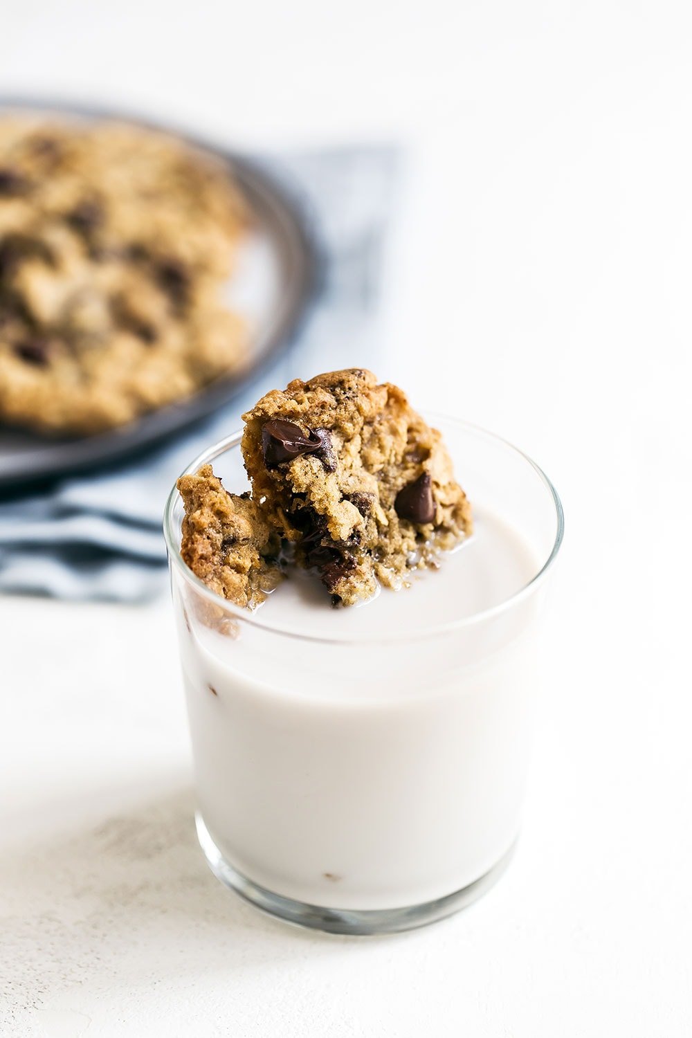 Cookies sitting in a glass of cold milk, ready to be enjoyed
