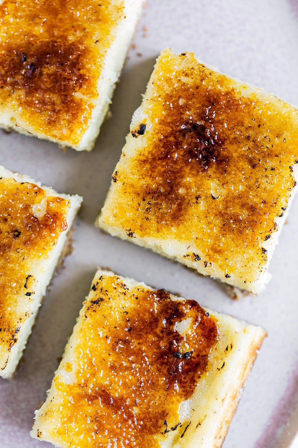 These Creme Brulee Cheesecake Bars turn the classic French dessert into something even easier and tastier! Graham cracker crust, vanilla bean cheesecake filling, and a bruleed sugar topping. YUM!