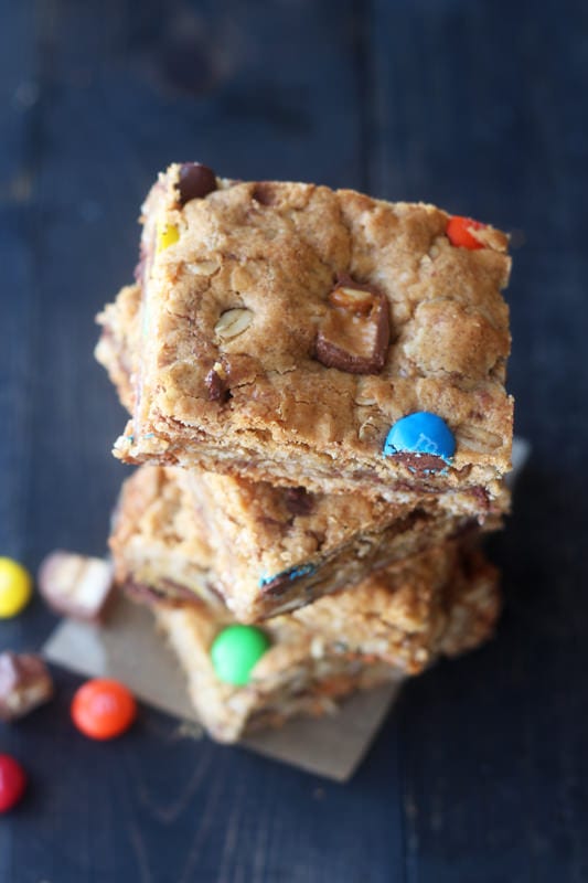 Monster Cookie Bars are filled with oatmeal, peanut butter, chocolate chips, and leftover Halloween candy!