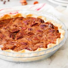 Chocolate pecan pie in a glass pie pan.