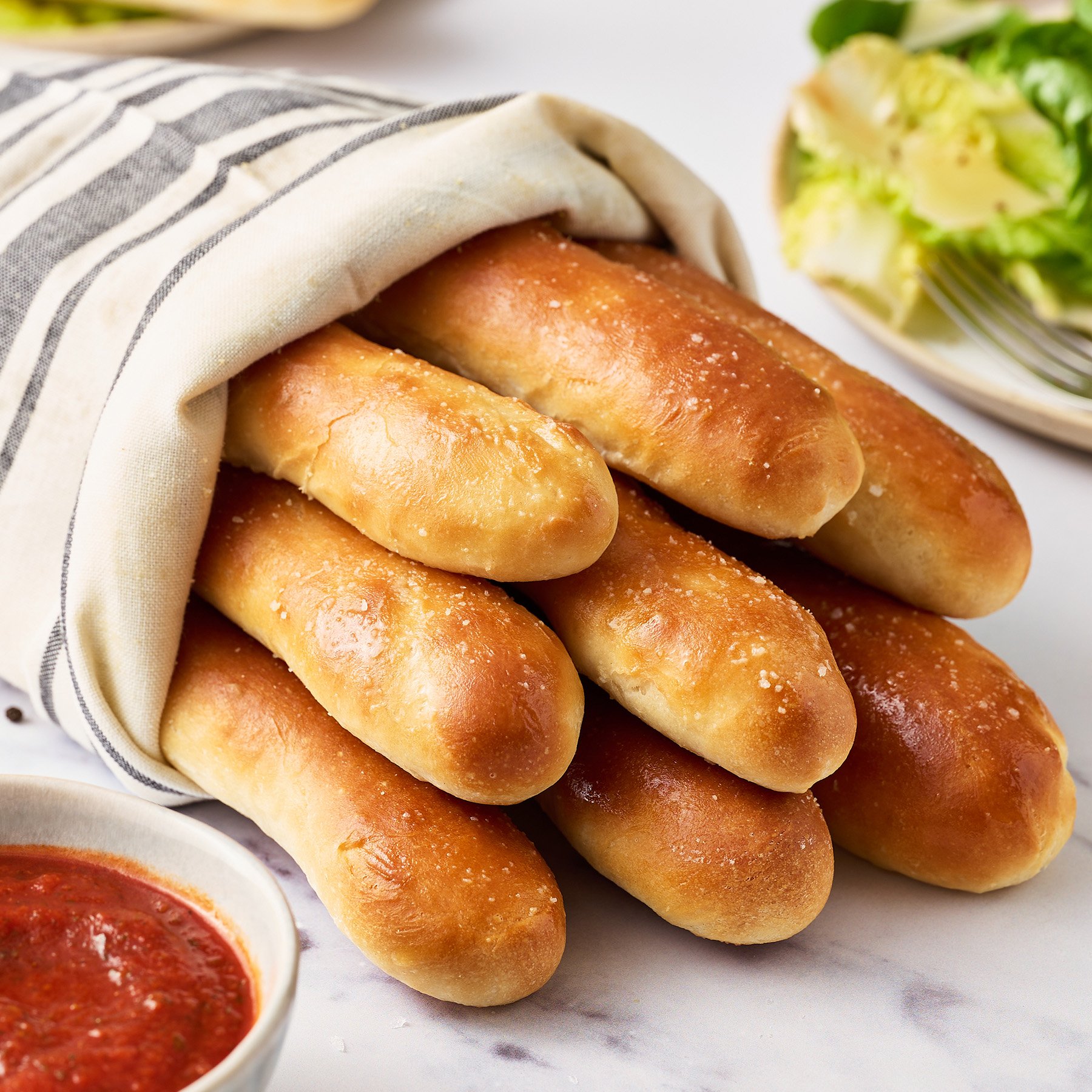 copycat olive garden breadsticks wrapped in a linen cloth