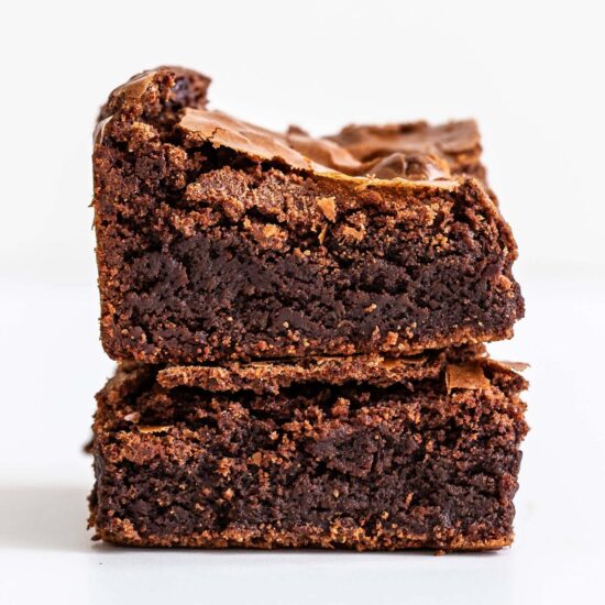 ultimate fudgy brownies stacked on top of each other