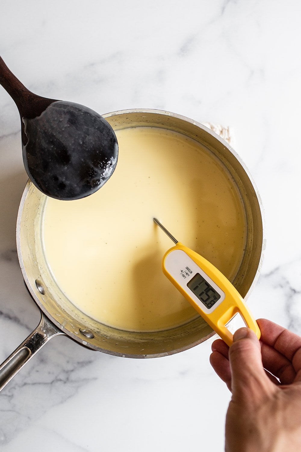 Using an instant-read thermometer to verify the mixture has cooked to the right temperature