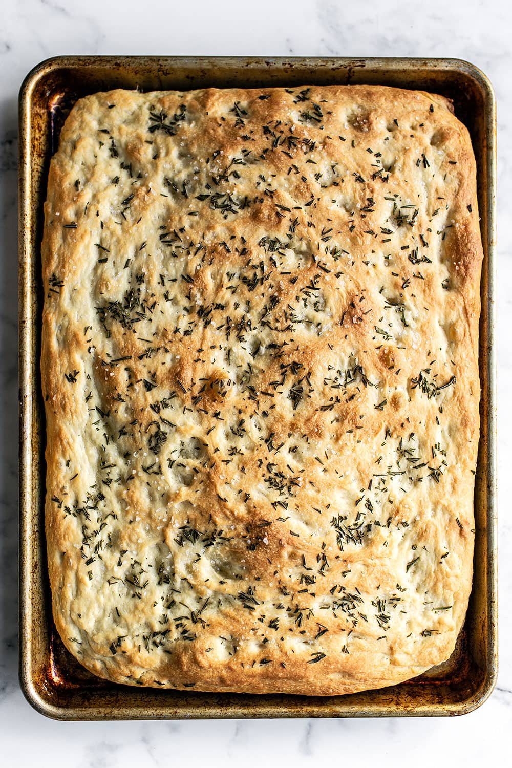 Tray of homemade rosemary focaccia bread fresh from the oven