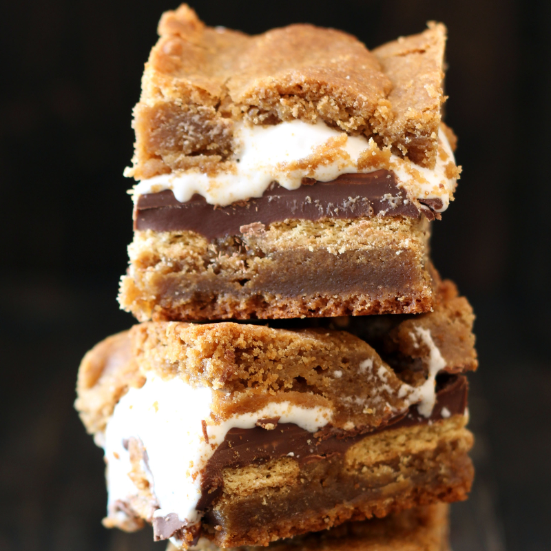 Peanut Butter S’mores Blondies, stacked on top of each other to show the various delicious, gooey layers