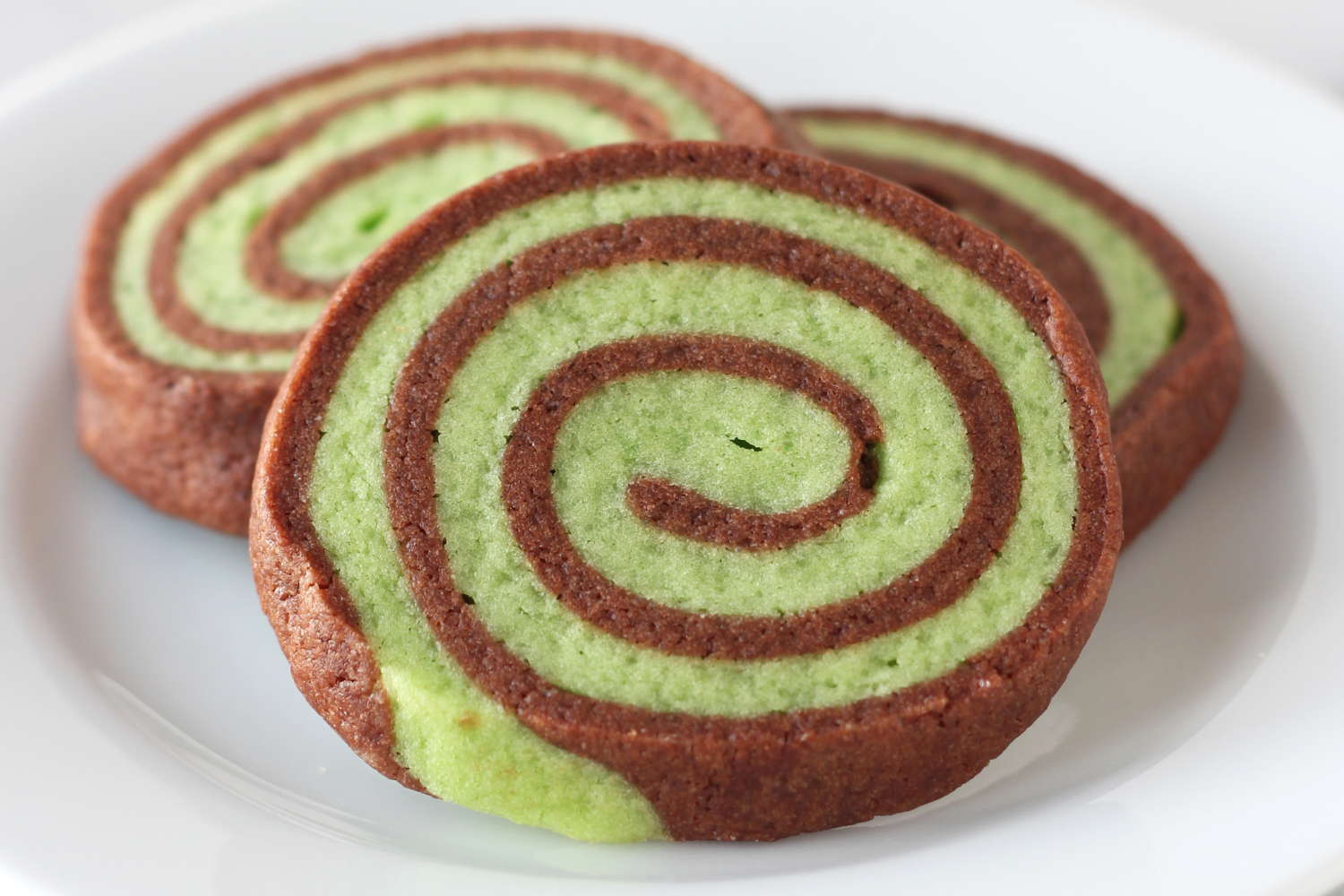 peppermint chocolate pinwheel cookies on a plate.