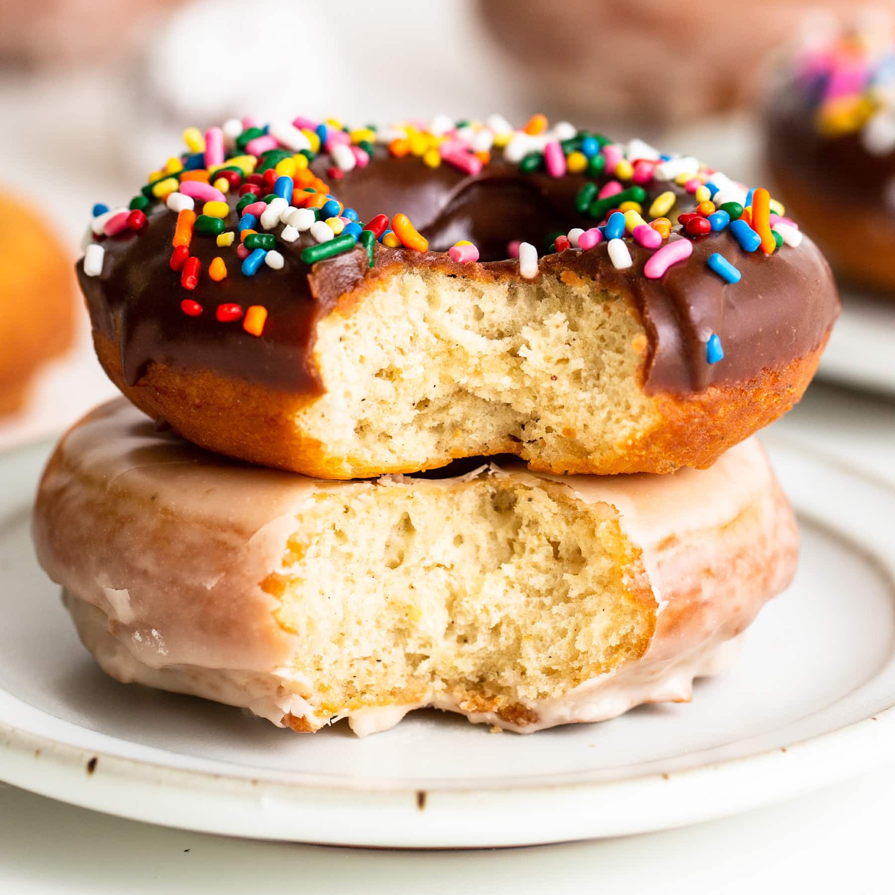 bite taken out of two homemade cake doughnuts stacked on top of each other