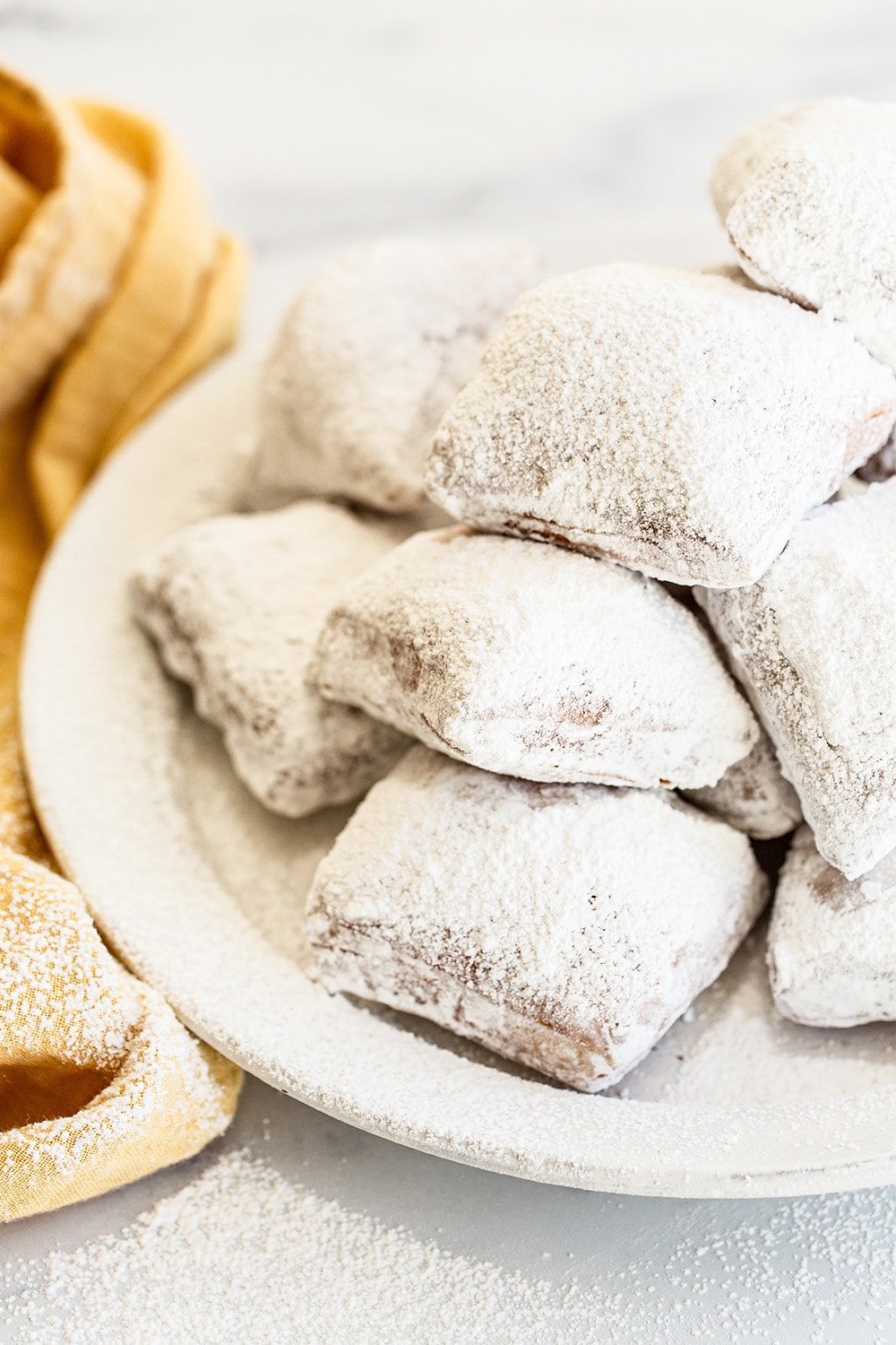 pile of freshly-made delicious beignets on a plate