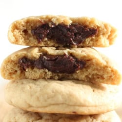 a few fudge-filled cookies stacked, with the top one broken open to show the fudge filling.