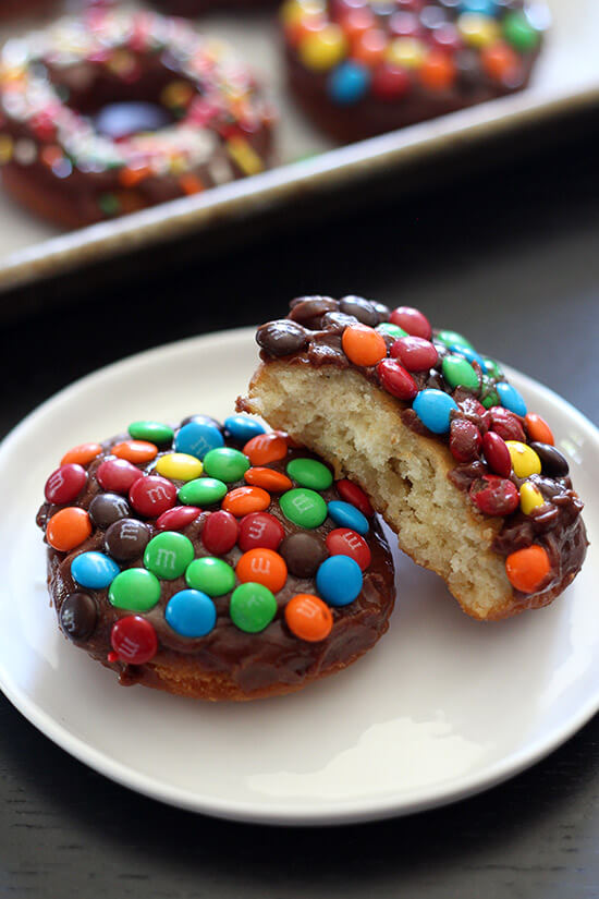 M&M Cake Doughnuts are fried perfection, topped with a thick chocolate glaze and crunchy m&m candies and are way quicker to make than yeast doughnuts!