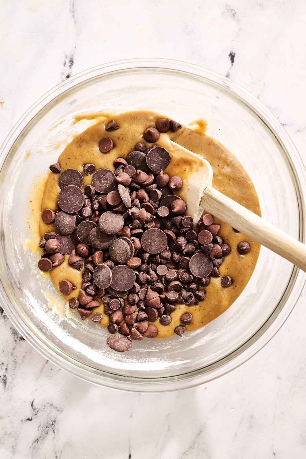 brown butter triple chocolate blondie batter in bowl with spatula