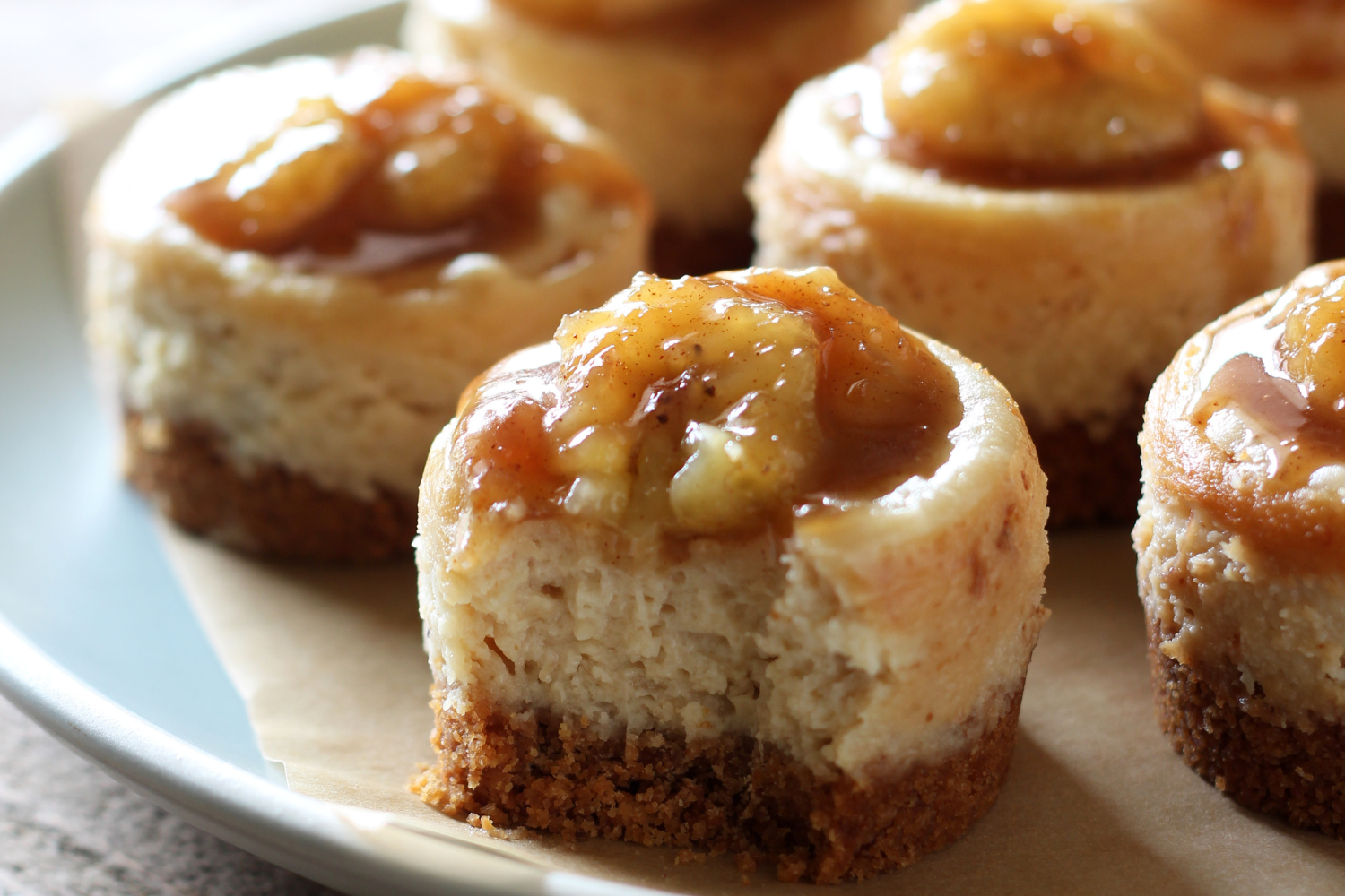 adorable little bananas foster cheesecakes on a plate