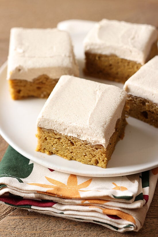 SO GOOD. Pumpkin Bars with Brown Sugar Frosting is the perfect fall crowd pleasing treat! Spiced thick & soft pumpkin bars and a thick layer of brown sugar frosting.