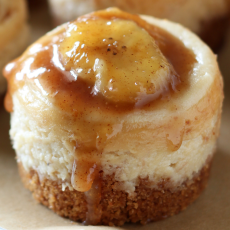 Mini Bananas Foster Cheesecakes, with gooey bourbon cinnamon banana sauce on top