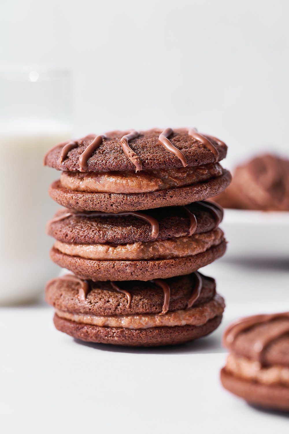 stack of homemade fudge rounds with a glass of milk