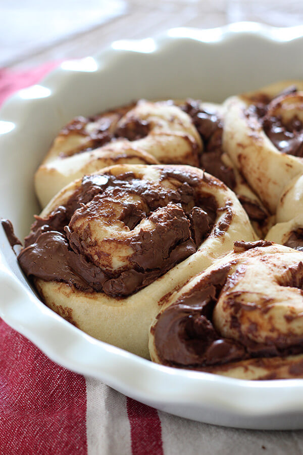 These take just ONE HOUR! Nutella Rolls with Cookie Butter Cream Cheese Glaze. Outrageously good!
