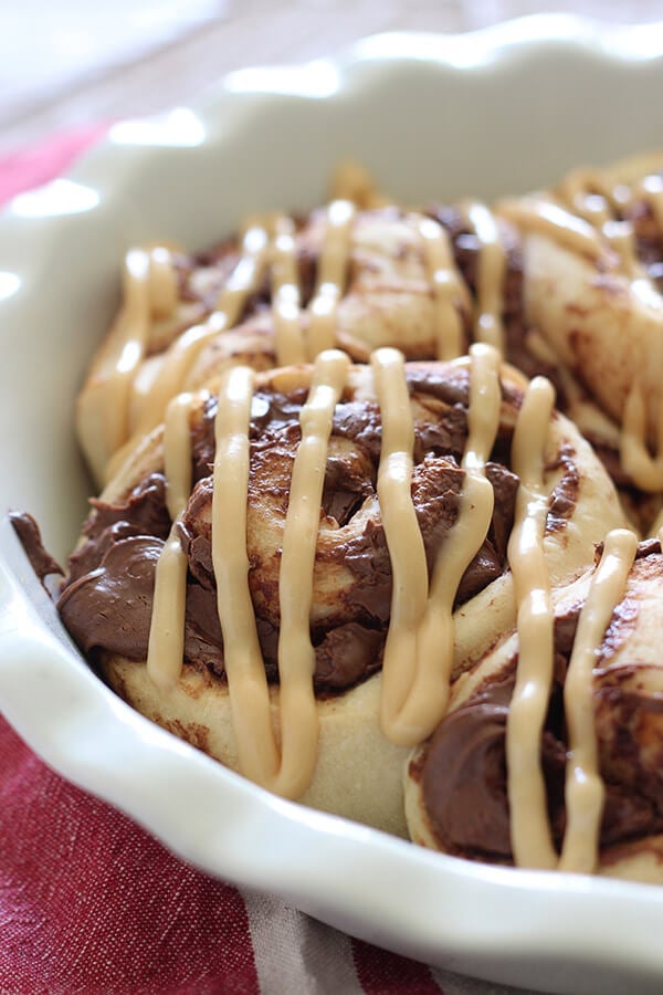 These take just ONE HOUR! Nutella Rolls with Cookie Butter Cream Cheese Glaze. Outrageously good!