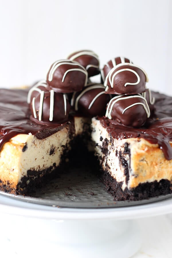 Oreo Cheesecake is a completely over-the-top sinful dessert with an Oreo crust, Oreo cheesecake filling, chocolate ganache, and Oreo truffles on top! Holy YUM.