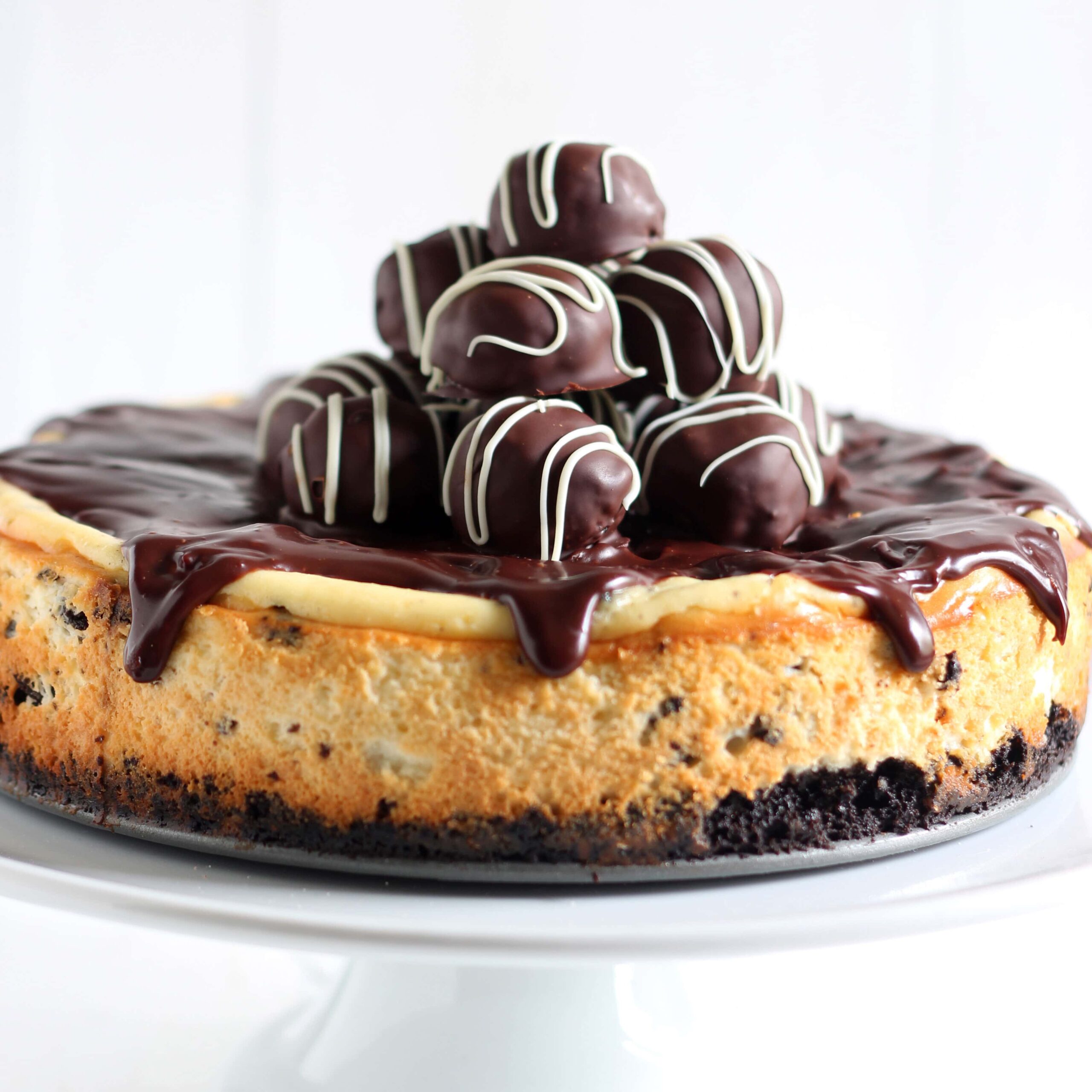 Oreo Truffle Cheesecake is a completely over-the-top sinful dessert with an Oreo crust, Oreo cheesecake filling, chocolate ganache, and Oreo truffles on top! Holy YUM.