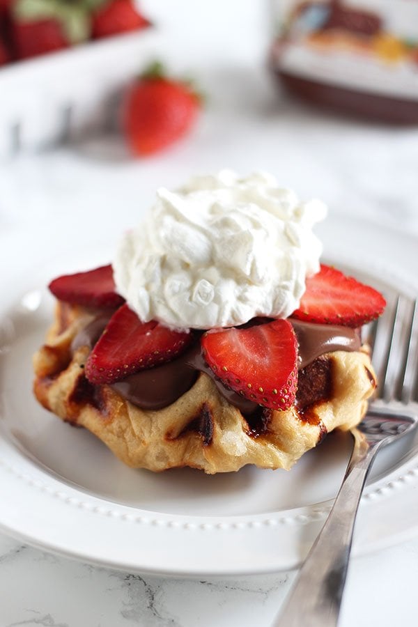 How to Make Belgian Liege Waffles - aka the BEST waffles EVER. Bits of crunchy caramelized sugar in every fluffy bite. I top mine with Nutella, fruit, and whipped cream!