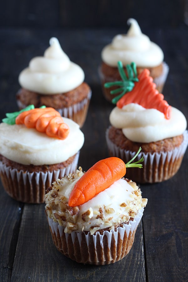 How to Make Decorative Carrots for your carrot cake or cupcakes. Includes a step-by-step video showing THREE ways to make cute carrots: with buttercream, candy melts, and marzipan. Perfect for spring!