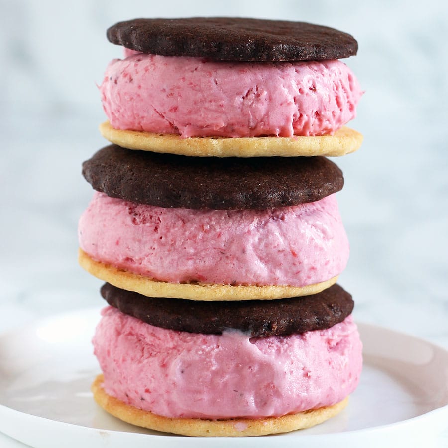 Neapolitan Ice Cream Sandwiches recipe with homemade fresh strawberry ice cream, vanilla wafer cookies, and chocolate wafer cookies sandwiched together.
