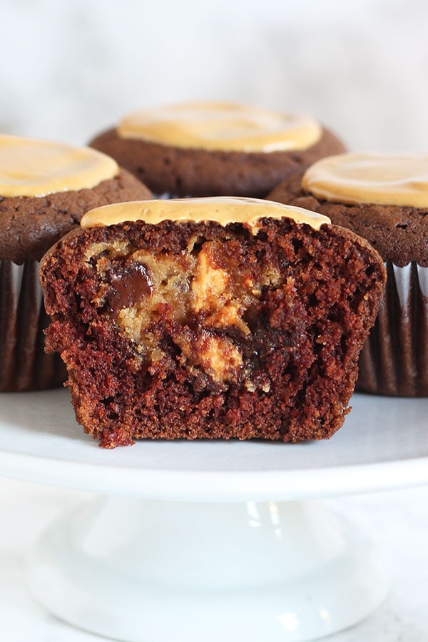 A hidden chocolate chip peanut butter cheesecake filling takes these Peanut Butter Cheesecake Stuffed Cupcakes to a whole new level. You'll LOVE this recipe.