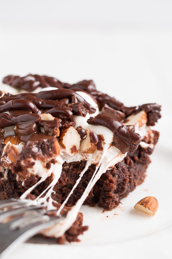 Rocky Road Brownies have a rich chocolate brownie base topped with a layer of puffy marshmallows, sprinkled with chocolate chips and almonds, and drizzled with chocolate frosting.