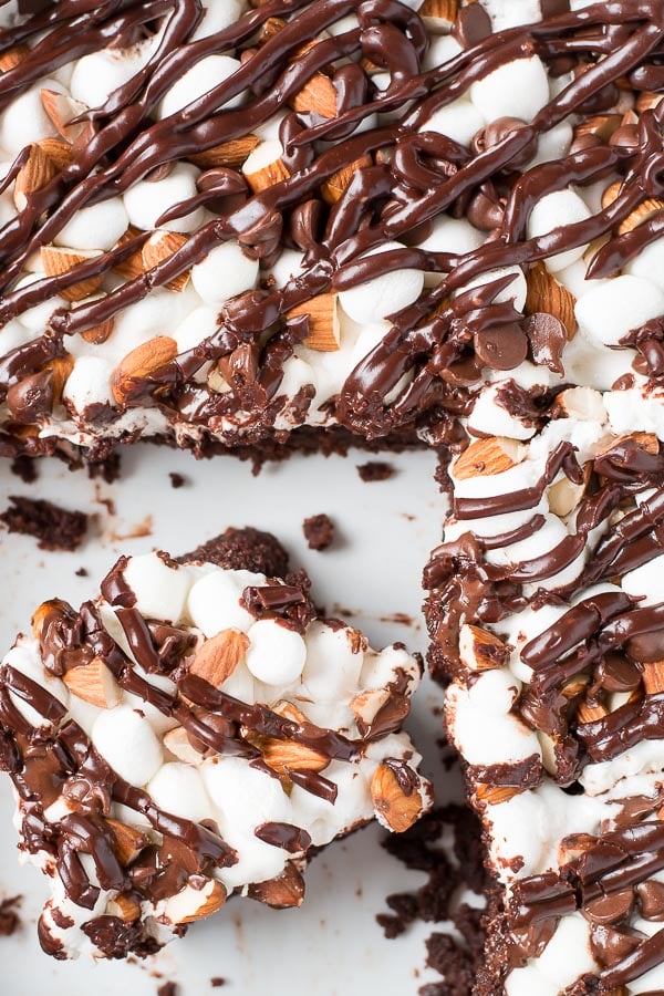 Rocky Road Brownies have a rich chocolate brownie base topped with a layer of puffy marshmallows, sprinkled with chocolate chips and almonds, and drizzled with chocolate frosting.