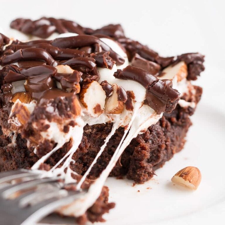 Rocky Road Brownies have a rich chocolate brownie base topped with a layer of puffy marshmallows, sprinkled with chocolate chips and almonds, and drizzled with chocolate frosting.