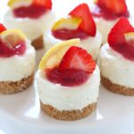 Fruity, tart, and ADORABLE, these No Bake Strawberry Lemonade Mini Cheesecakes are the perfect summer treat!