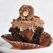 chocolate cupcake cut in half with nutella filling and nutella buttercream with ferrero rocher on top