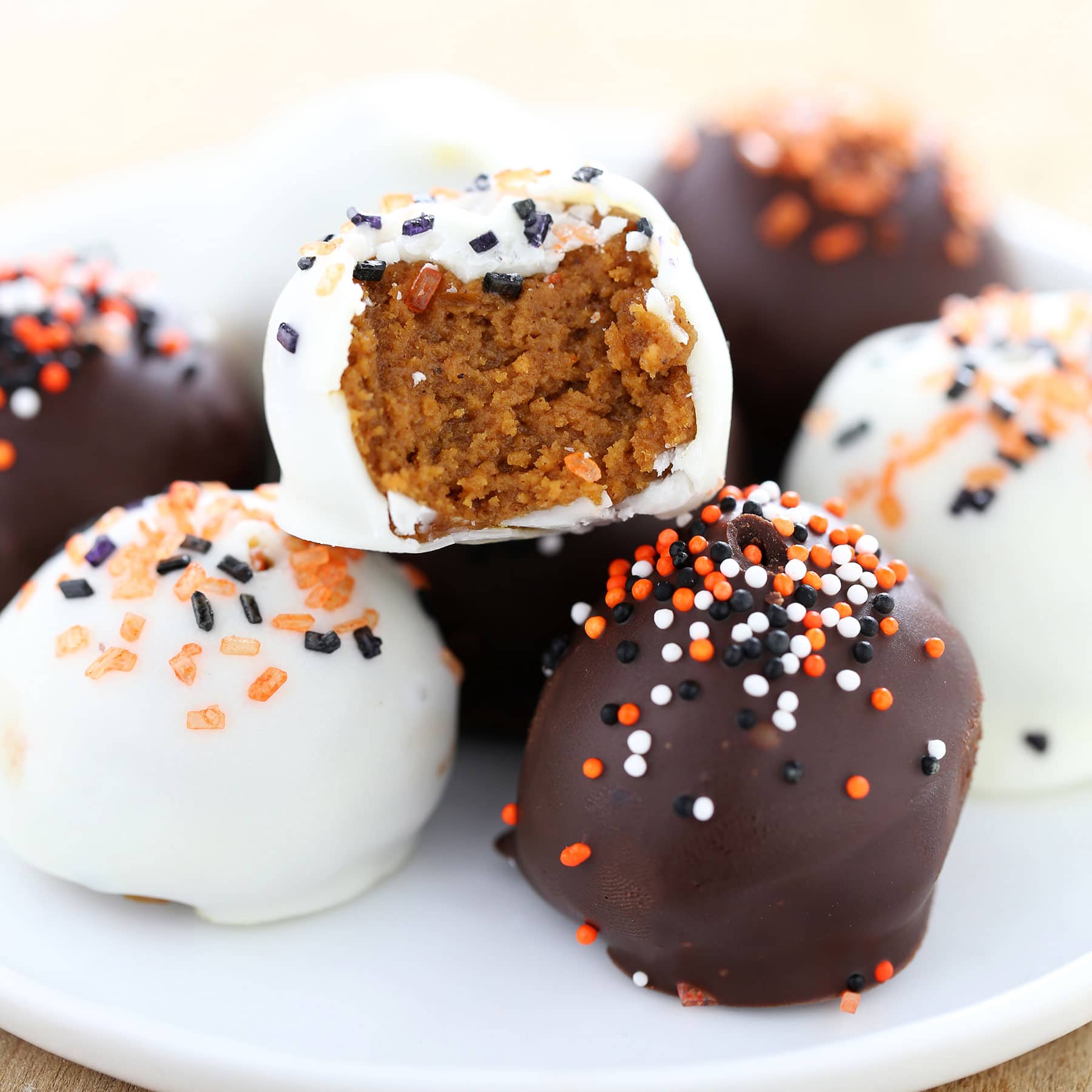 Pumpkin Cookie Butter Truffles are filled with cream cheese, pumpkin, Speculoos cookies, and tons of warm spices then dipped in chocolate. Fall perfection! No baking or chocolate tempering required!