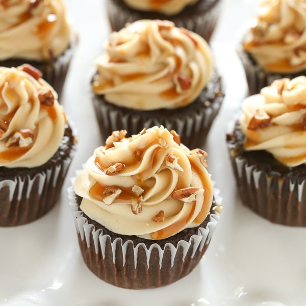 These Chocolate Turtle Cupcakes feature a soft and light chocolate cupcake, a rich caramel frosting, and are topped with caramel sauce and chopped pecans.