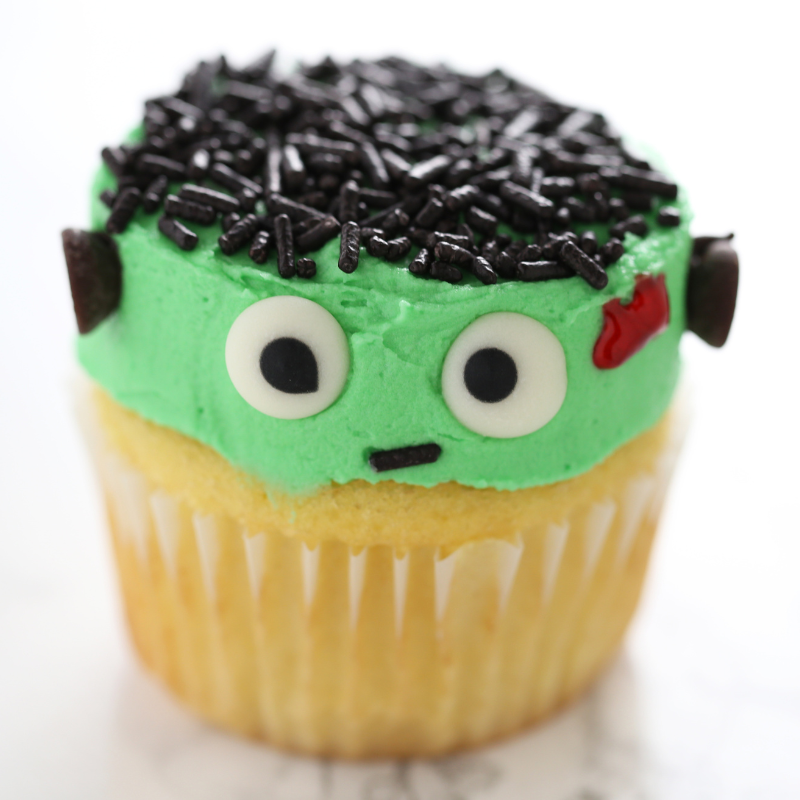 a cupcake with frosting and decorations to look like Frankenstein's monster