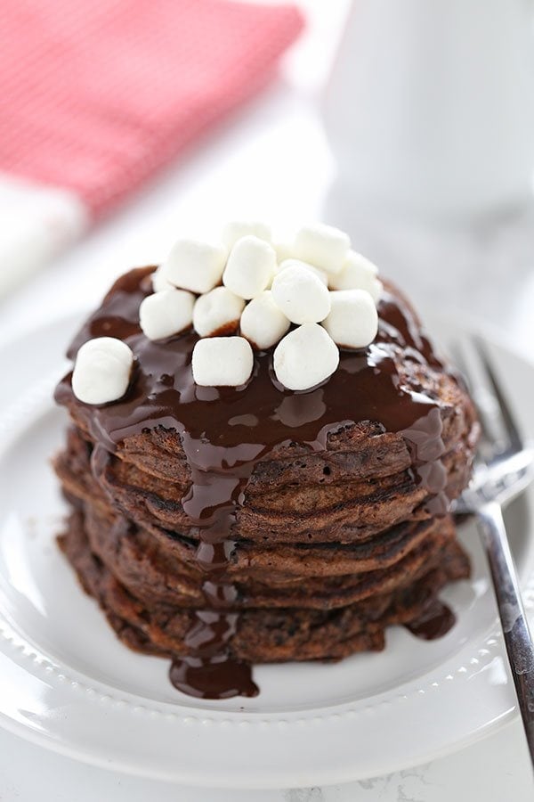 Hot Chocolate Pancakes feature rich chocolate buttermilk pancakes with a thick chocolate fudge topping and garnish with mini marshmallows. 