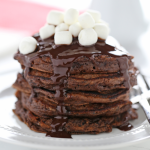 a stack of hot chocolate pancakes with mini marshmallows on top.
