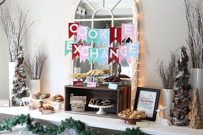 the full Cookie Exchange table with platters of cookies and some Christmas decor. 