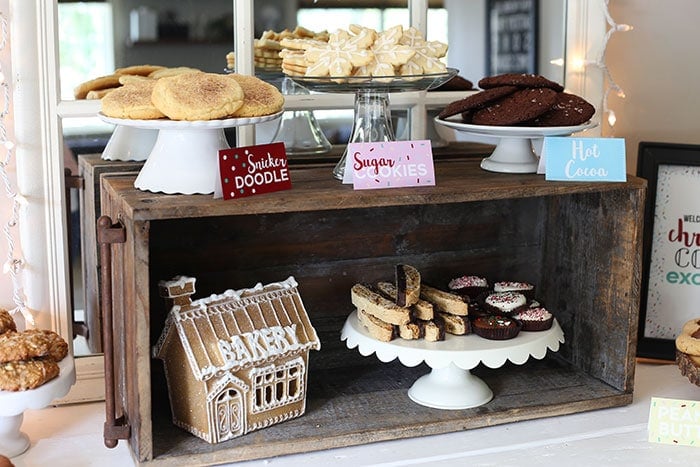 three cake stands with a mix of cookies and labels in front of each, showing what cookies are which.