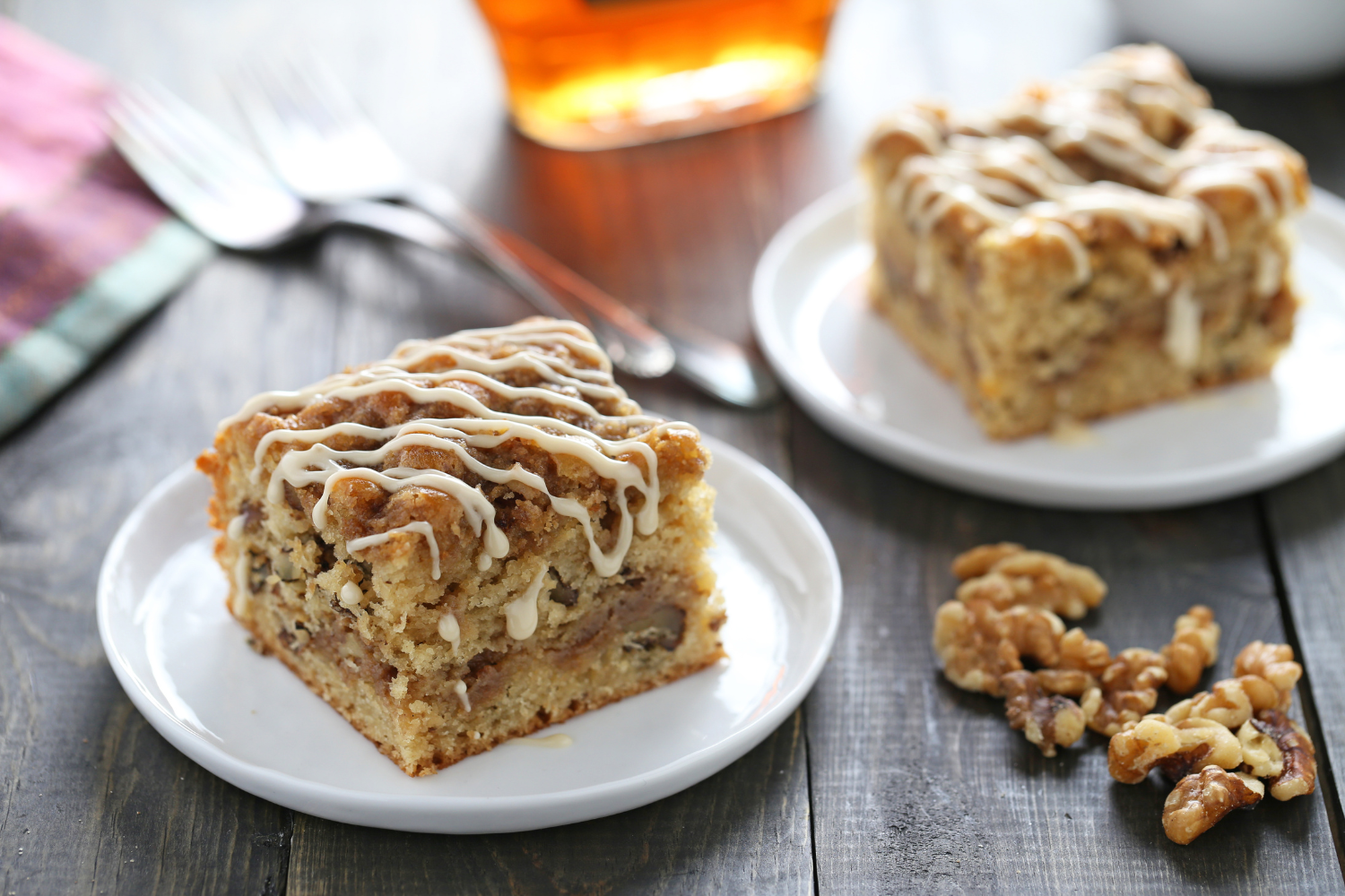 slices of maple walnut coffee cake on plates with forks, ready to serve