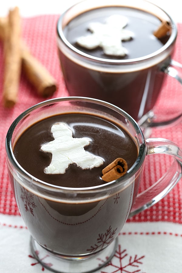 This recipe for Gingerbread Hot Chocolate complete with adorable gingerbread men whipped cream cubes is the perfect warm drink for a cold day.